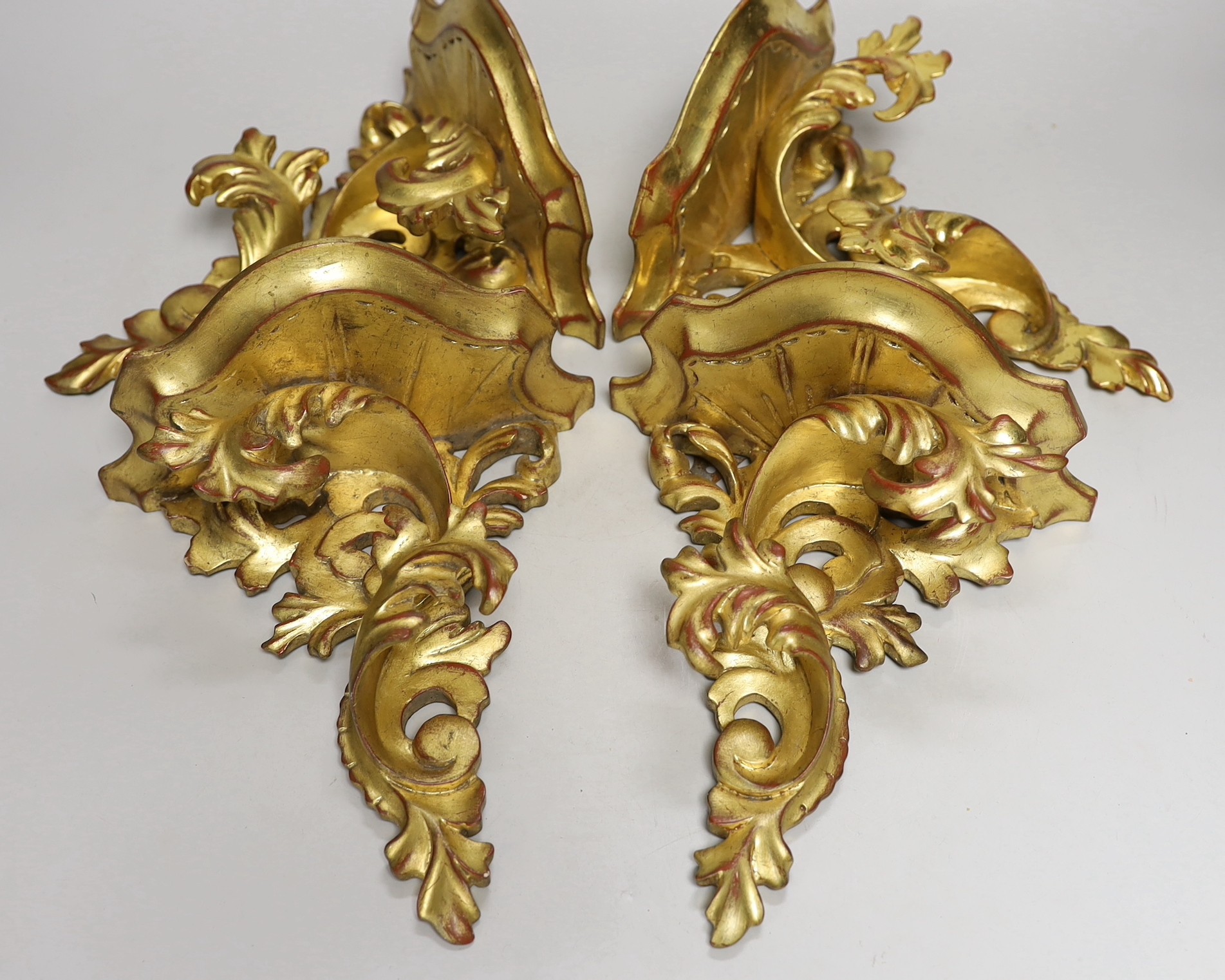 A set of four gilt wood wall brackets 22.5cm tall x 20.5cm wide